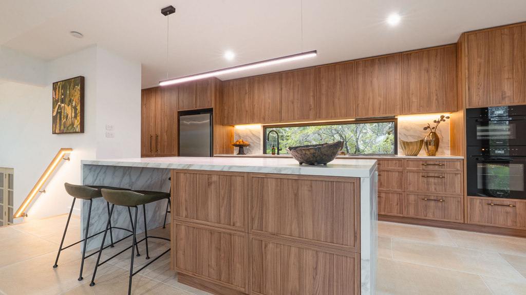 Modern kitchen with wooden cabinets and a central island.