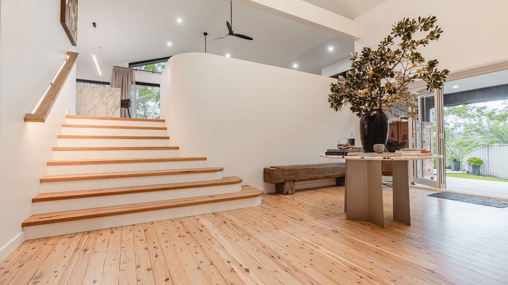 Modern interior with wooden staircase and living area